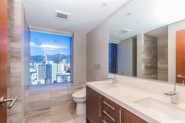 bathroom featuring tile patterned floors, vanity, and toilet