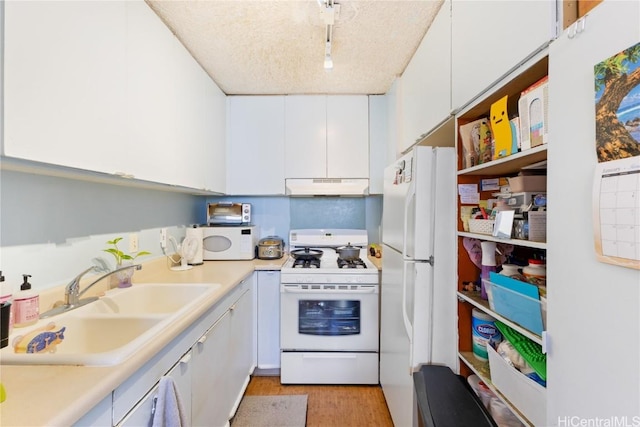 kitchen featuring sink, white appliances, light hardwood / wood-style flooring, track lighting, and white cabinets