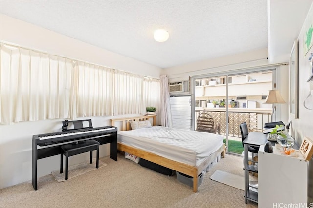 carpeted bedroom with access to exterior and an AC wall unit