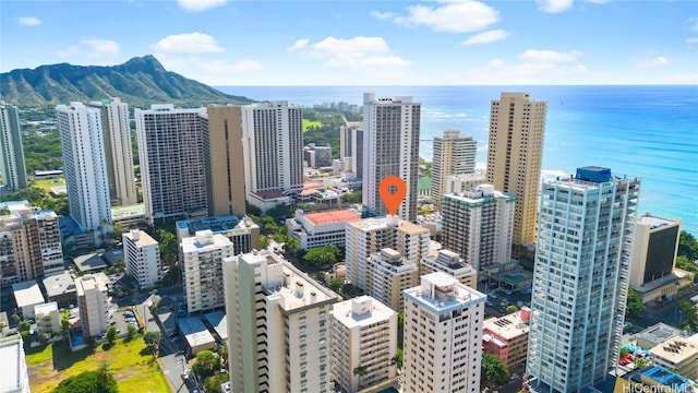 property's view of city with a water and mountain view