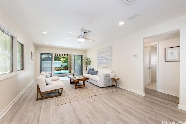 living room with ceiling fan and light hardwood / wood-style flooring