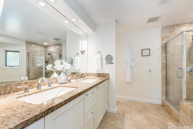 bathroom featuring vanity, tile patterned flooring, and a shower with shower door