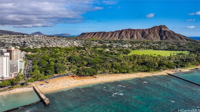 view of mountain feature with a view of the beach and a water view