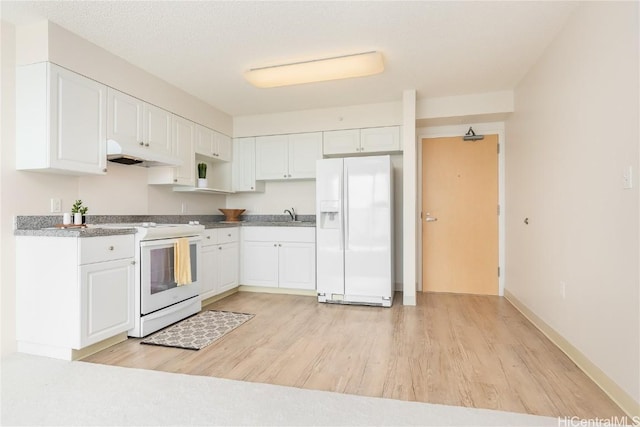 kitchen with white appliances, light hardwood / wood-style flooring, white cabinetry, and sink