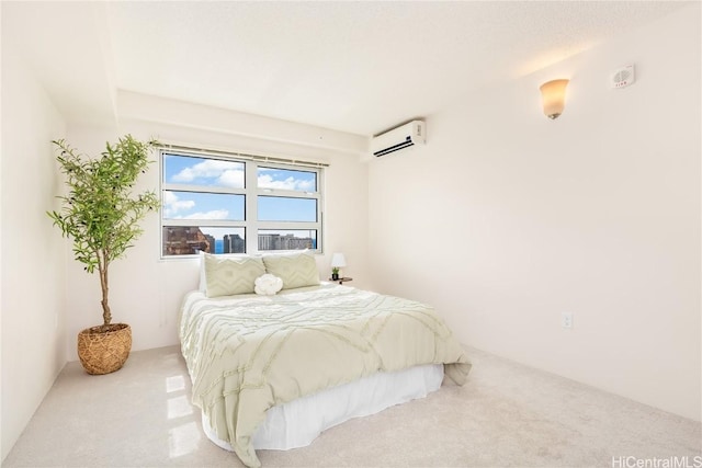 bedroom featuring carpet flooring and a wall mounted air conditioner