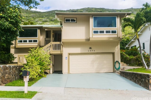 view of front facade featuring a mountain view and a garage