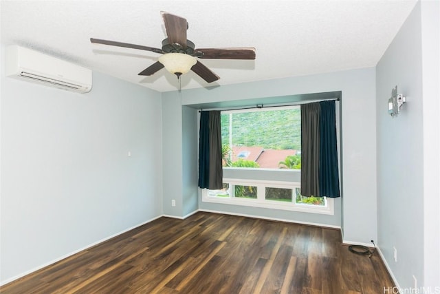 empty room with a textured ceiling, dark hardwood / wood-style floors, ceiling fan, and a wall mounted AC