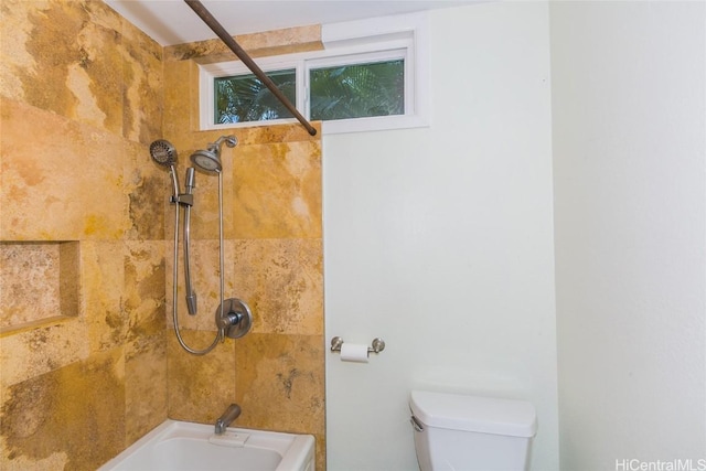 bathroom featuring toilet and tiled shower / bath combo