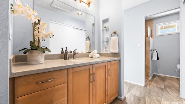 bathroom featuring baseboards and vanity