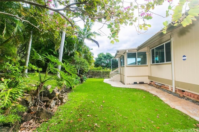 view of yard with a sunroom