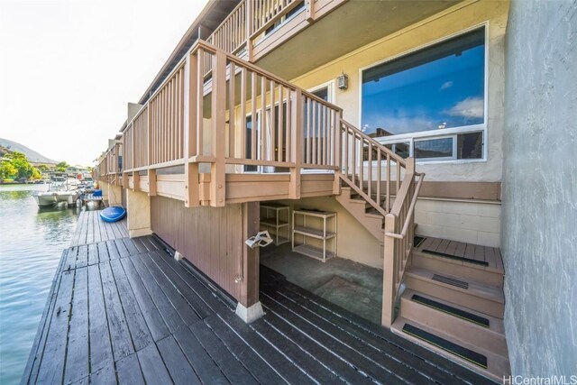 deck with a water view and stairway