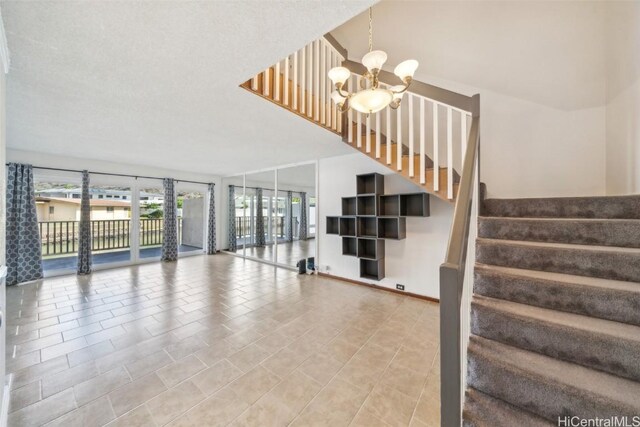 stairs featuring baseboards and a notable chandelier