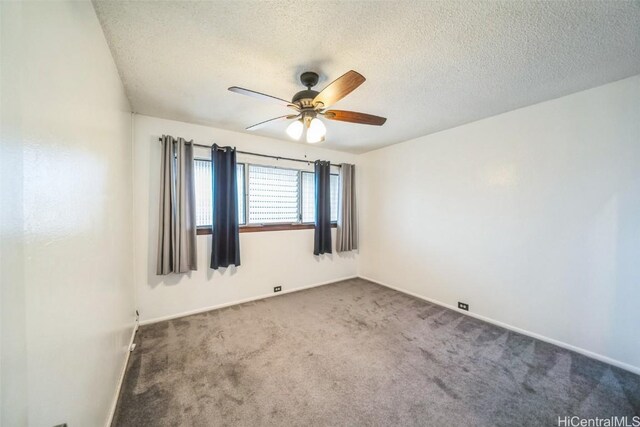 empty room with carpet floors, ceiling fan, a textured ceiling, and baseboards