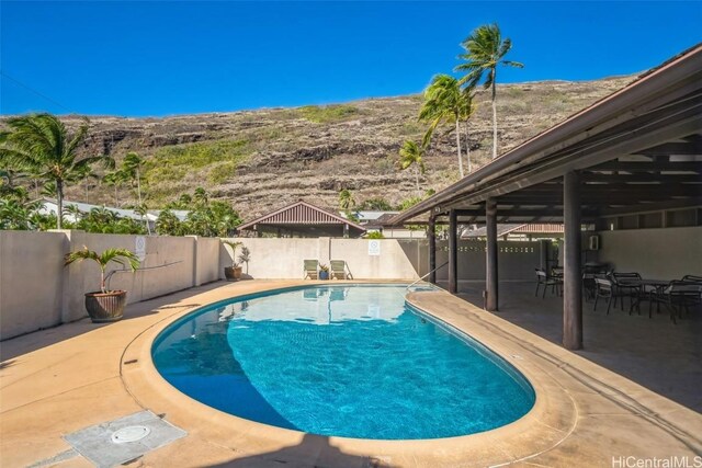 view of swimming pool featuring a fenced in pool, a fenced backyard, and a patio