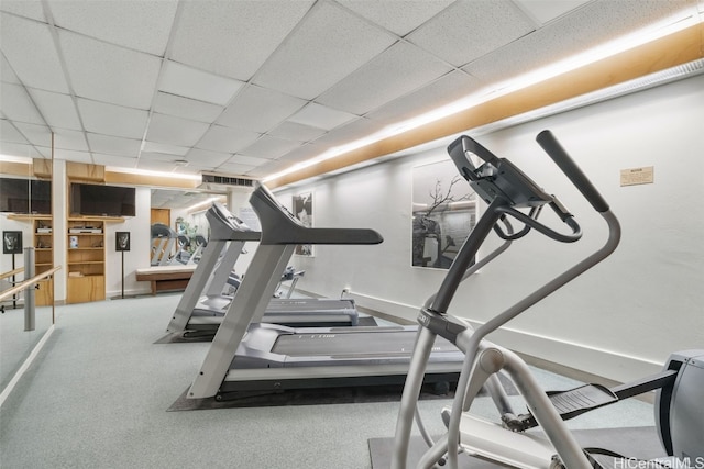 workout area featuring a paneled ceiling and carpet