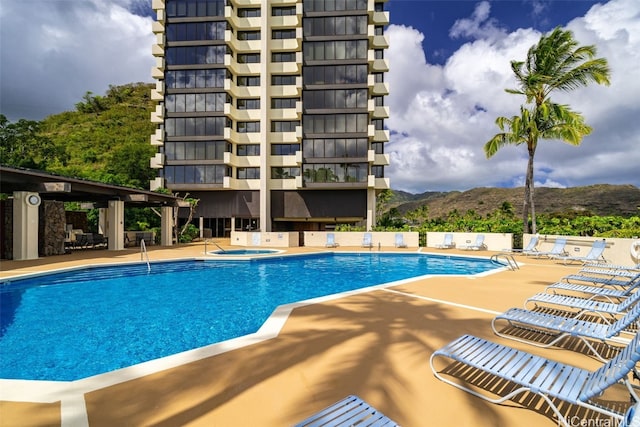 view of pool with a mountain view and a patio