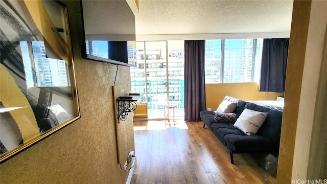 living room with a textured ceiling and wood finished floors