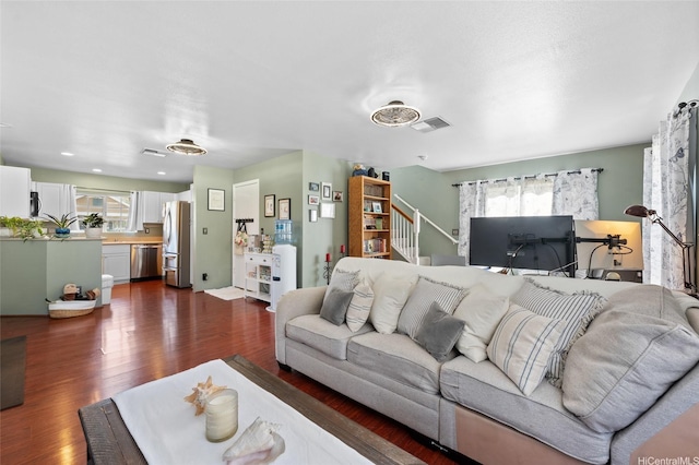 87-1980 Pakeke St Unit J, Waianae, HI 96792 - living room with healthy amount of natural light, dark wood-style flooring, and stairway