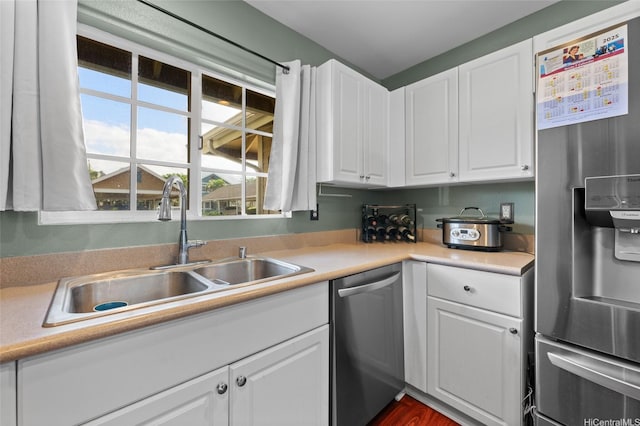 87-1980 Pakeke St Unit J, Waianae, HI 96792 - kitchen featuring appliances with stainless steel finishes, a sink, white cabinets, and light countertops