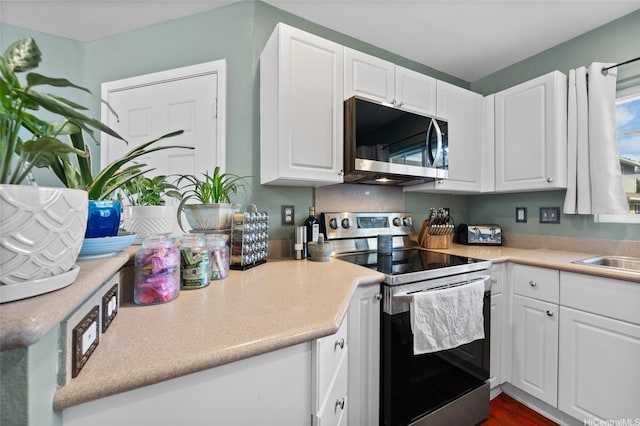 87-1980 Pakeke St Unit J, Waianae, HI 96792 - kitchen featuring stainless steel appliances, white cabinets, light countertops, and a sink