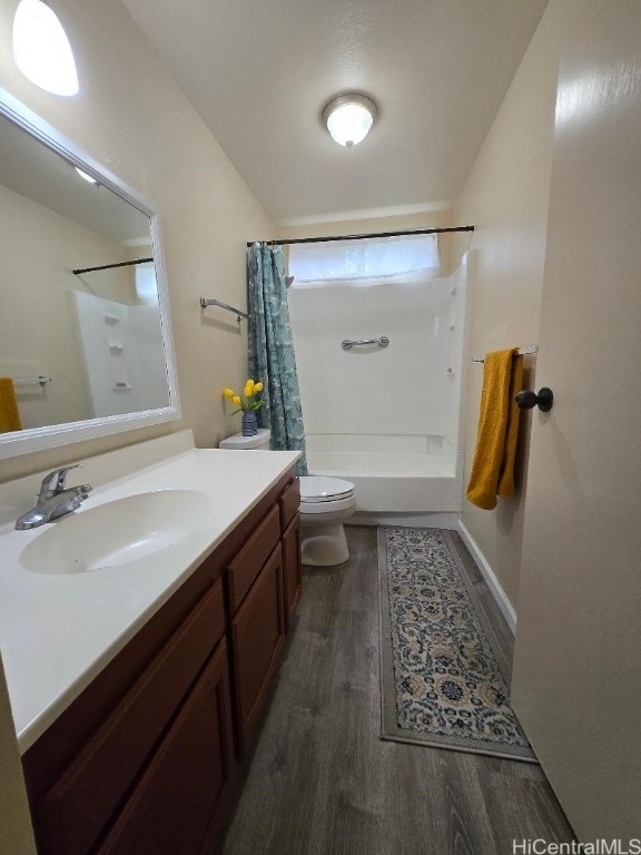 full bathroom with toilet, shower / bath combination with curtain, hardwood / wood-style floors, and vanity