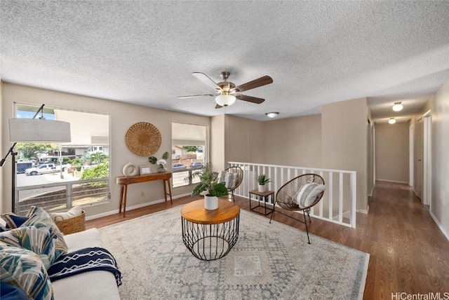 sitting room with wood-type flooring and a textured ceiling