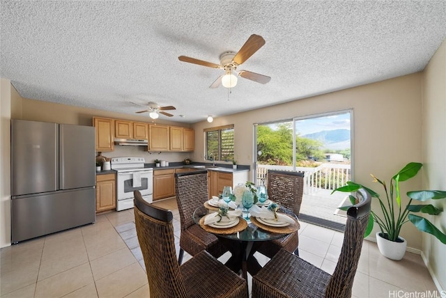 dining space with sink and light tile patterned floors