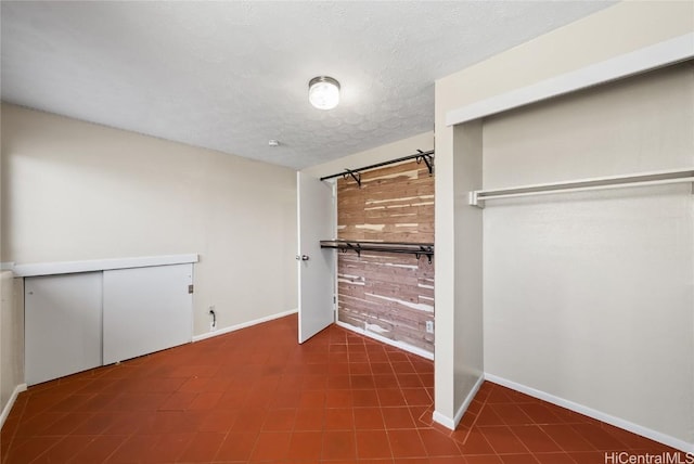 unfurnished bedroom featuring a closet and a textured ceiling