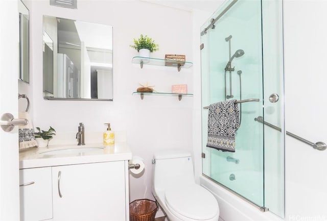 full bathroom with toilet, combined bath / shower with glass door, and vanity