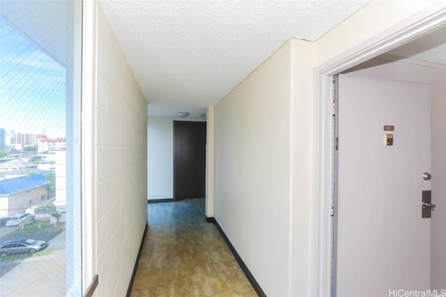 hallway featuring a textured ceiling