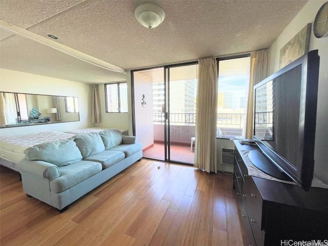 living room with hardwood / wood-style floors, a textured ceiling, and plenty of natural light