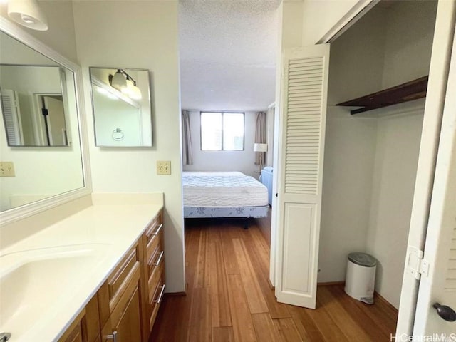 bathroom featuring vanity, a textured ceiling, and hardwood / wood-style flooring