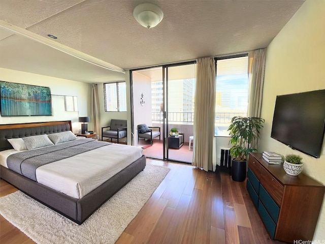 2240 Kuhio Ave Unit 1210, Honolulu, HI 96815 - bedroom featuring access to outside, dark wood finished floors, and a textured ceiling