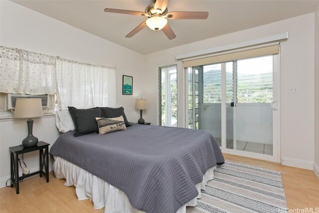 bedroom with access to outside, light hardwood / wood-style flooring, lofted ceiling, cooling unit, and ceiling fan