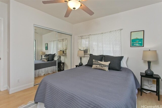 bedroom with hardwood / wood-style flooring, ceiling fan, and a closet