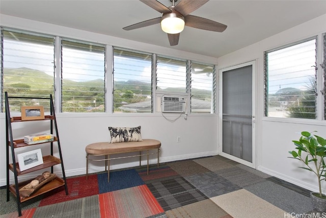 sunroom featuring cooling unit and ceiling fan