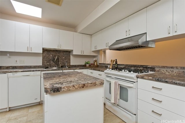 kitchen featuring a kitchen island, sink, white cabinets, and white appliances