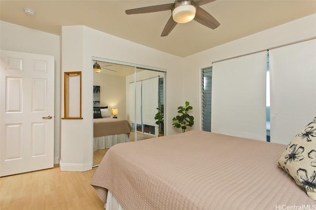 bedroom featuring ceiling fan, a closet, and light wood-type flooring