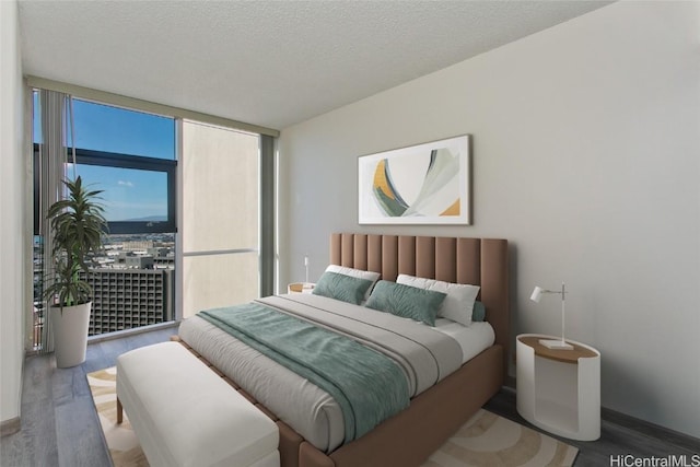 bedroom with hardwood / wood-style flooring, a textured ceiling, and floor to ceiling windows