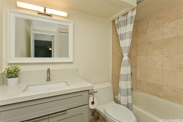 full bathroom with vanity, shower / bath combo with shower curtain, and toilet