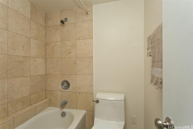 bathroom with toilet and tiled shower / bath combo