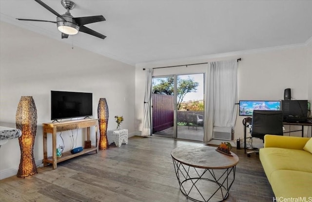 living room featuring lofted ceiling, baseboards, wood finished floors, and crown molding