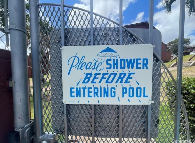 community / neighborhood sign featuring fence