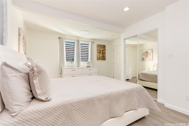 bedroom featuring light hardwood / wood-style floors and a closet