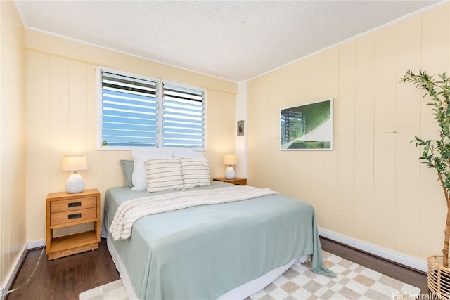 bedroom featuring dark wood-type flooring and a textured ceiling