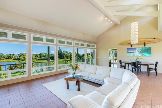 living room featuring a water view, light tile patterned floors, track lighting, high vaulted ceiling, and beam ceiling