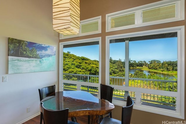 sunroom featuring a water view