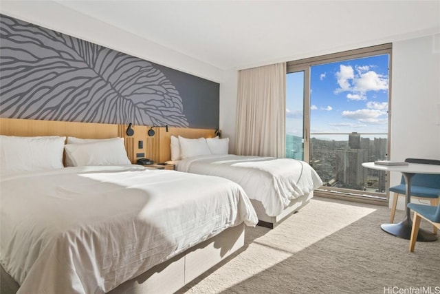 bedroom with expansive windows and carpet