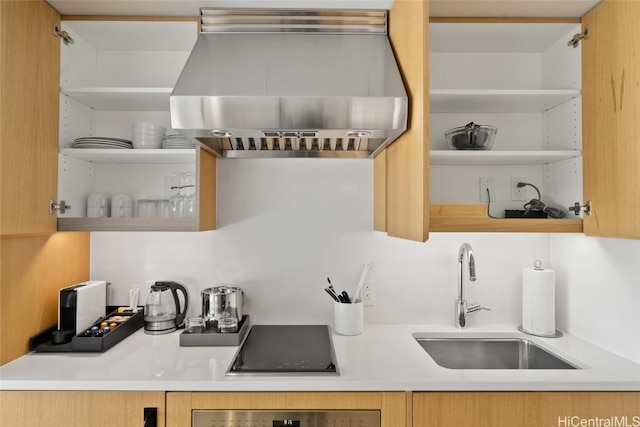 kitchen with black electric stovetop, sink, wall chimney range hood, and oven