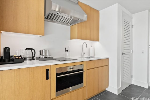 kitchen with sink, ventilation hood, black electric cooktop, dark tile patterned flooring, and stainless steel oven